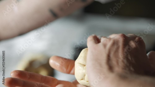 Wallpaper Mural A person is kneading dough with their hands. The dough is located between their fingers and palms Torontodigital.ca