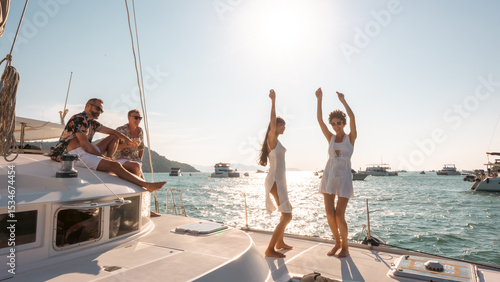 Obraz na plátně Happy Caucasian man and woman enjoy travel nature ocean celebration party drinking champagne and dancing together on luxury catamaran boat yacht in the sea on summer beach holiday vacation