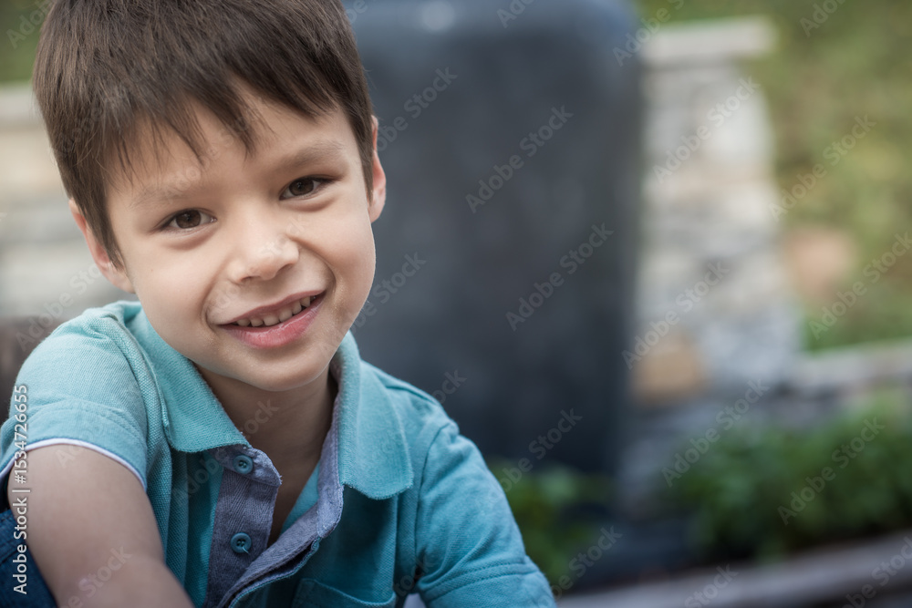 Cute 6 year old mixed race boy plays happily in his suburban backyard Cute 6 year old mixed race boy plays happily in his suburban backyard