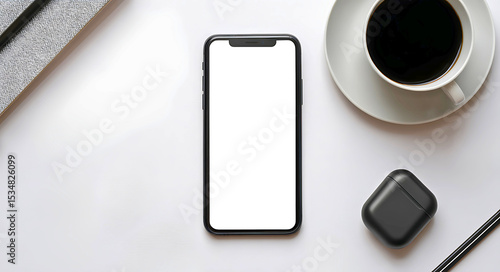 A white or transparent screen smartphone lying on a white table with accessories like earbuds and a coffee cup. top-down perspective.