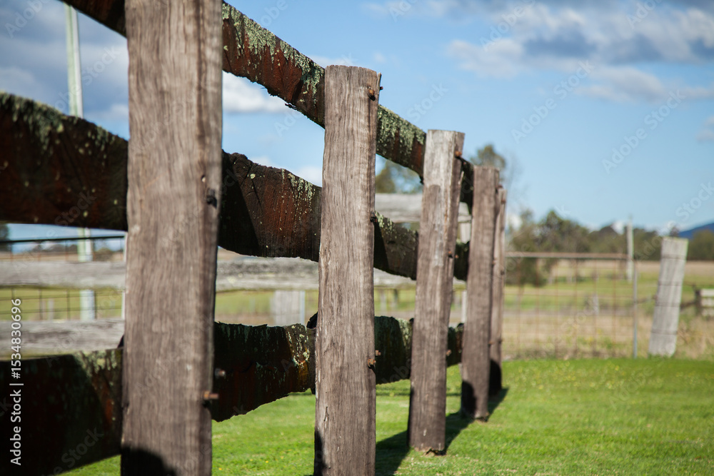 Old wooden post and rail farm fence of cattle yards Old wooden post and rail farm fence of cattle yards