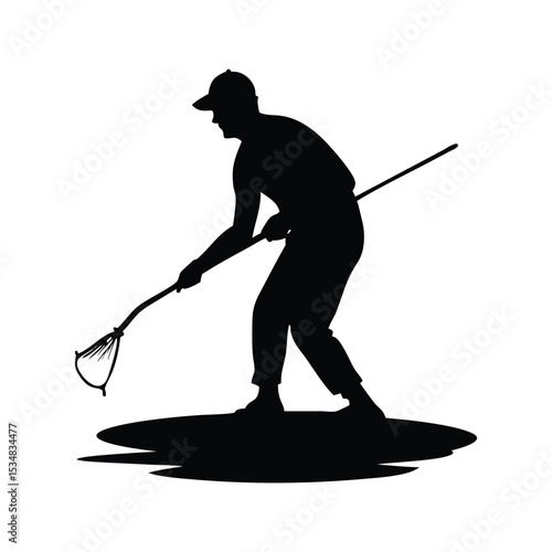 Silhouette of a man using a long handled net