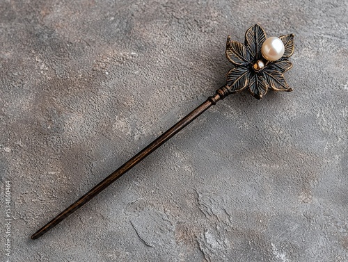 Elegant hair stick with pearl and leaf detail.