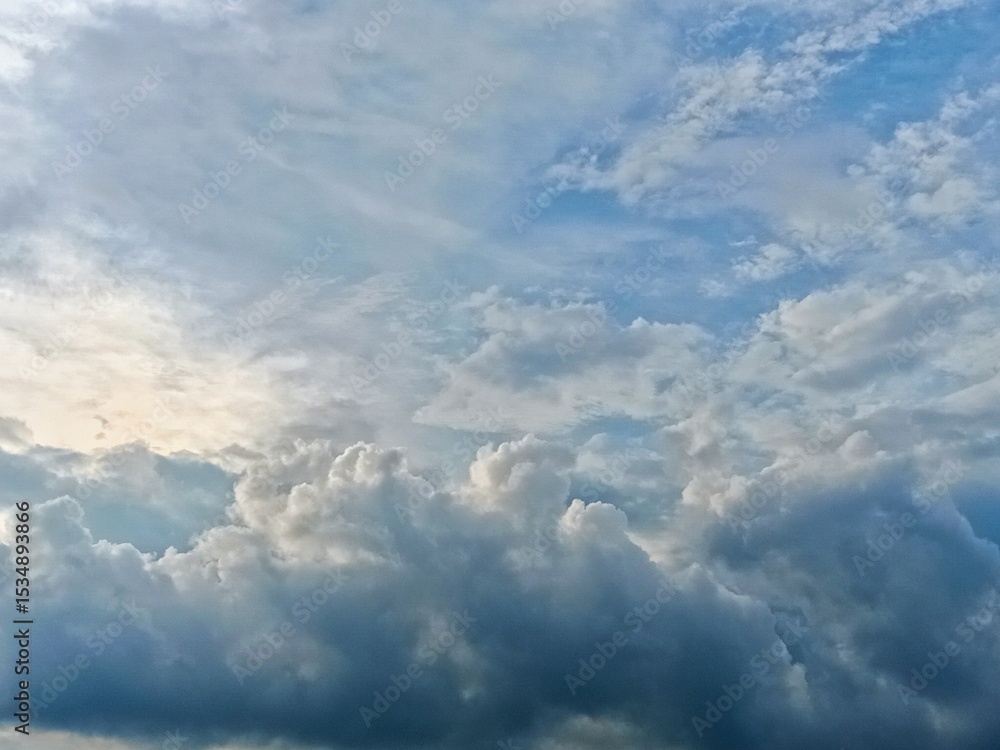 A breathtaking view of cumulus clouds forming in a partly sunny sky, offering a majestic yet calm natural background. A breathtaking view of cumulus clouds forming in a partly sunny sky, offering a majestic yet calm natural background.
