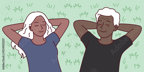 Group of black dark brown skinned senior people with white hair resting on grass together. Represents healthy aging, inclusion, relaxation, and emotional unity in nature