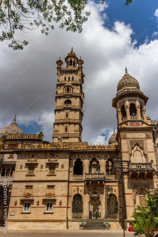Elaborate palace with tall tower under cloudy sky. Elaborate palace with tall tower under cloudy sky.