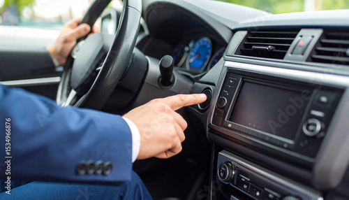 Businessman hand pressing start button in modern car interior, ready to drive, showing technology and convenience in transportation