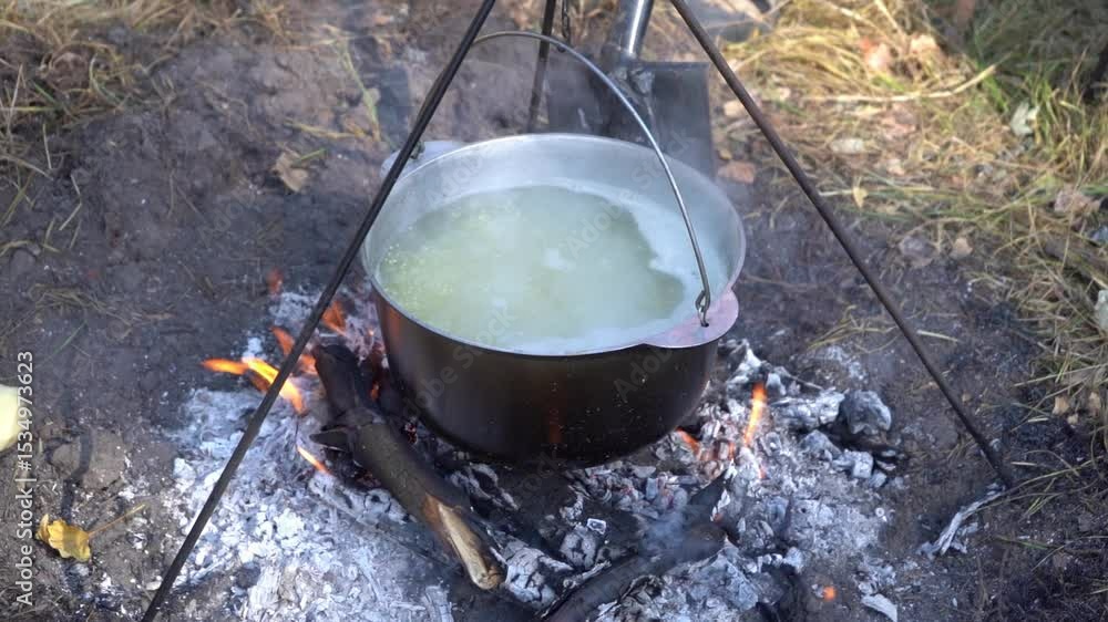 Cauldron on the fire. Cooking food on a hike. Food soup outdoor in a camping. Travel tourism extreme. Forest trip Cauldron on the fire. Cooking food on a hike. Food soup outdoor in a camping. Travel tourism extreme. Forest trip