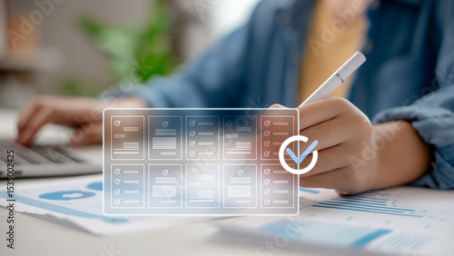 Digital document checklist with person using stylus and laptop. Concept of workflow automation, paperless system, task tracking, and smart office document management technology.