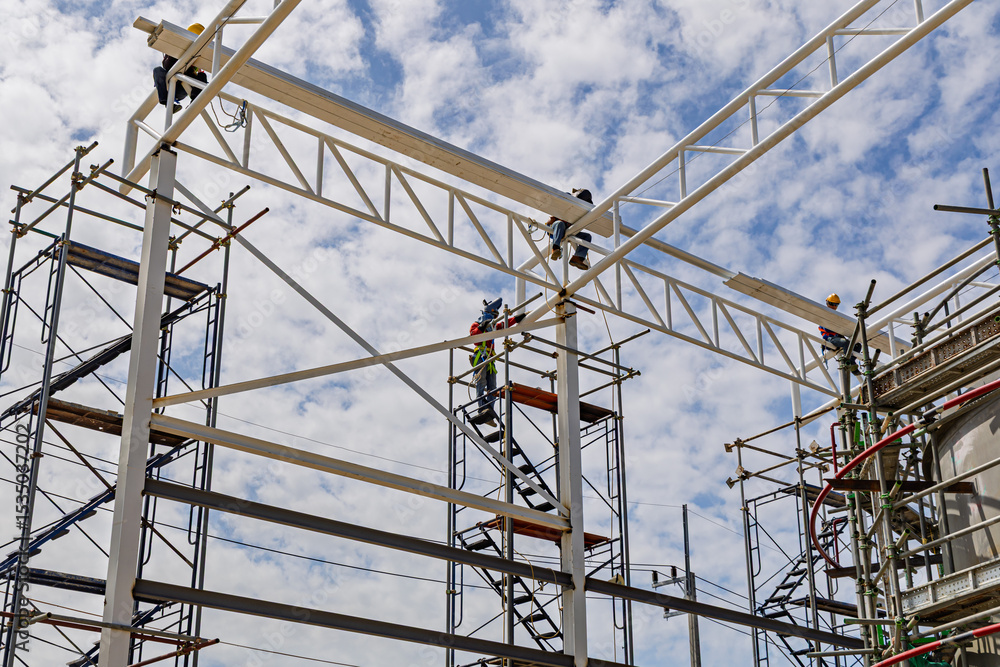 Naklejka premium Architect on site construction roof workers on a scaffold
