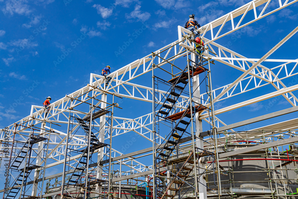 Fototapeta premium Architect on site construction roof workers on a scaffold