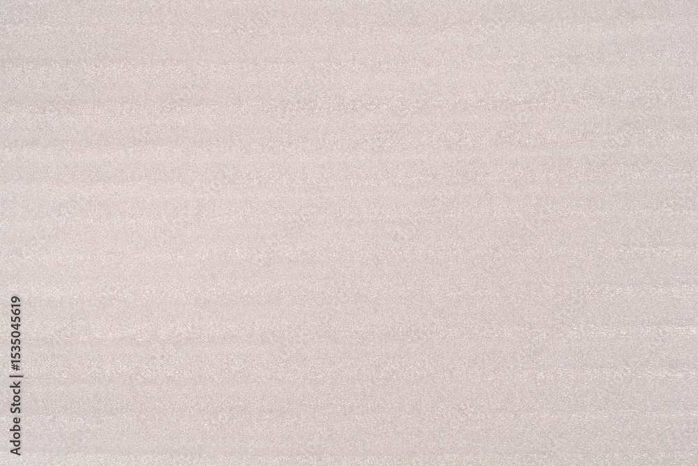 Fototapeta premium A close-up of the texture of a light grey EPE foam sheet with horizontal striations
