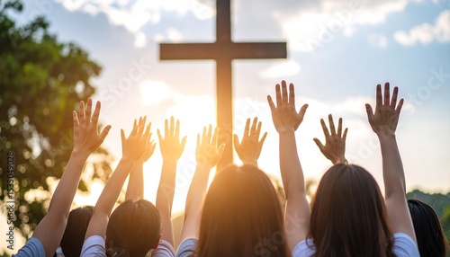 Hands raised in praise towards a cross