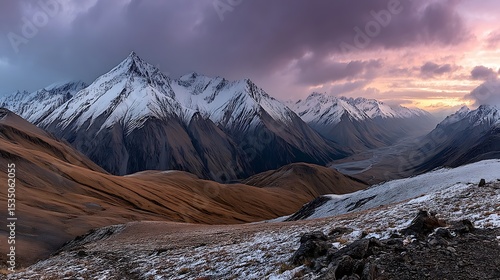 the image presents a panoramic landscape of a mountainous region under a dramatic sky