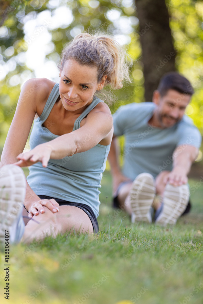 Fototapeta premium a couple stretching bodies warming up for jogging