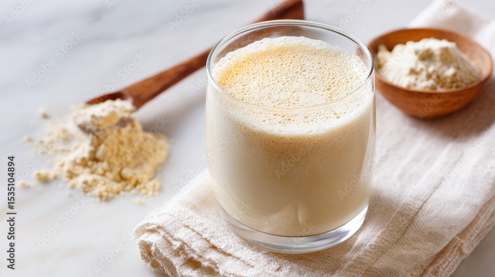 Stunning photo of dairy-Free Vanilla Protein Drink for Bodybuilding and Nutrition on White Surface. Stunning photo of dairy-Free Vanilla Protein Drink for Bodybuilding and Nutrition on White Surface.