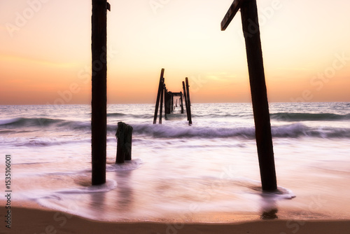 The old wooden bridge on the beach in sunset at Khao Pilai, Phangnga, Thailand