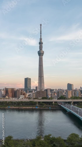 Aerial view time lapse 4k Video of Tokyo sky tree and Tokyo city from day to night sunset at Tokyo, Japan. Vertical video. 