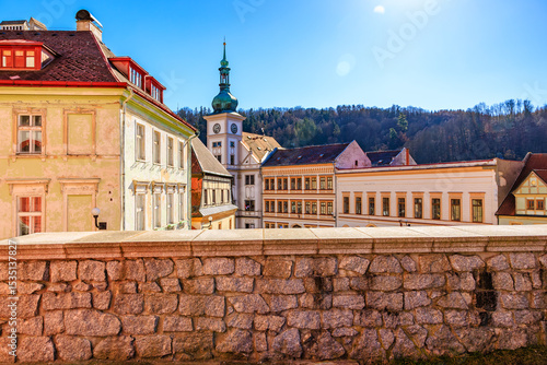 Quadro su tela Scenic view of historic town square with stone wall and colorful buildings