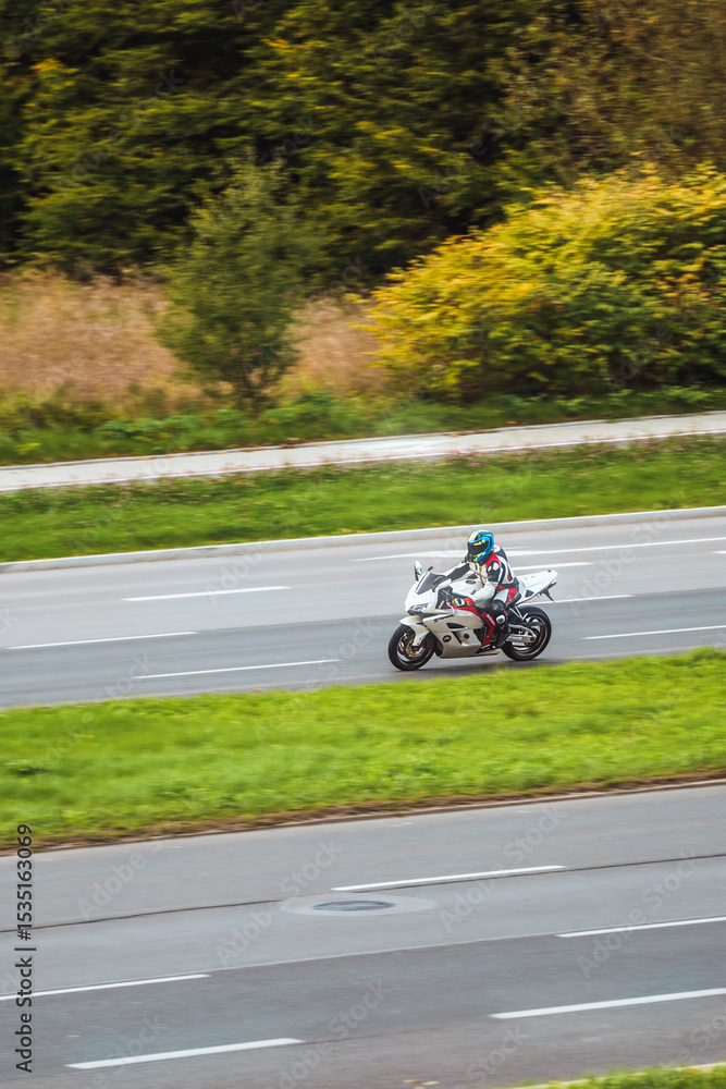 Fototapeta premium Motorbike and scenic roadway in autumn setting