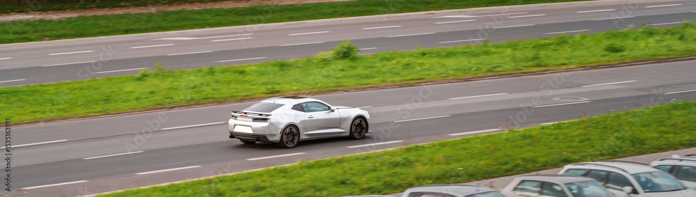 Fototapeta premium Silver sports car driving on highway