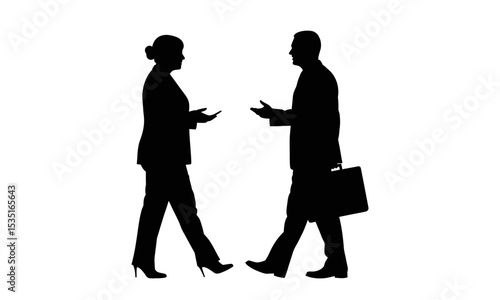 Silhouette of a businesswoman and businessman walking and discussing
