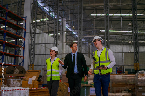 Fototapeta Blue collar workers are working and meeting at warehouse.