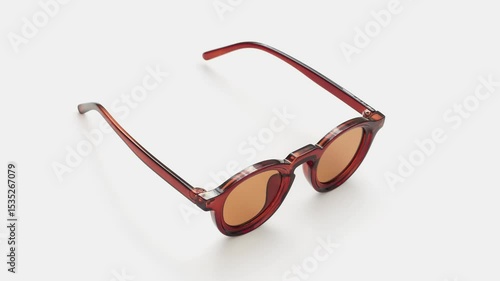 Close-up shot of stylish sunglasses on a white background, highlighting their sleek design and reflective lenses.