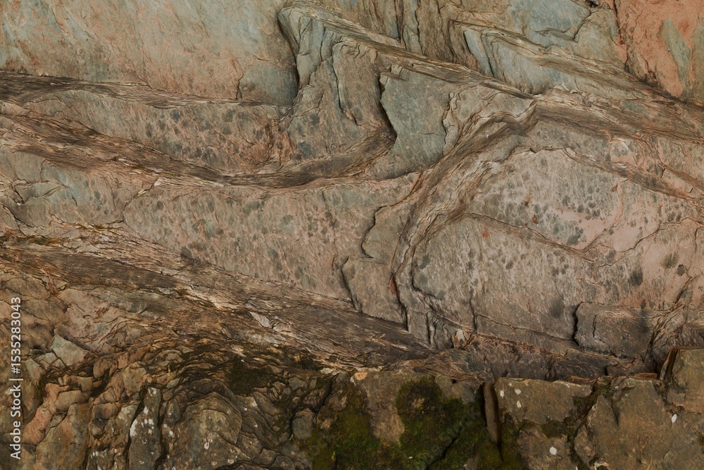 Obraz premium Close-up view of layered, textured rock formations with varying shades of brown, gray, and pink