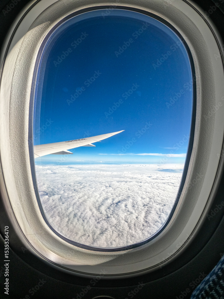 Fototapeta premium Airplane Wing View Over Clouds