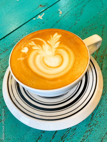 Artistic Cappuccino on Striped Saucer