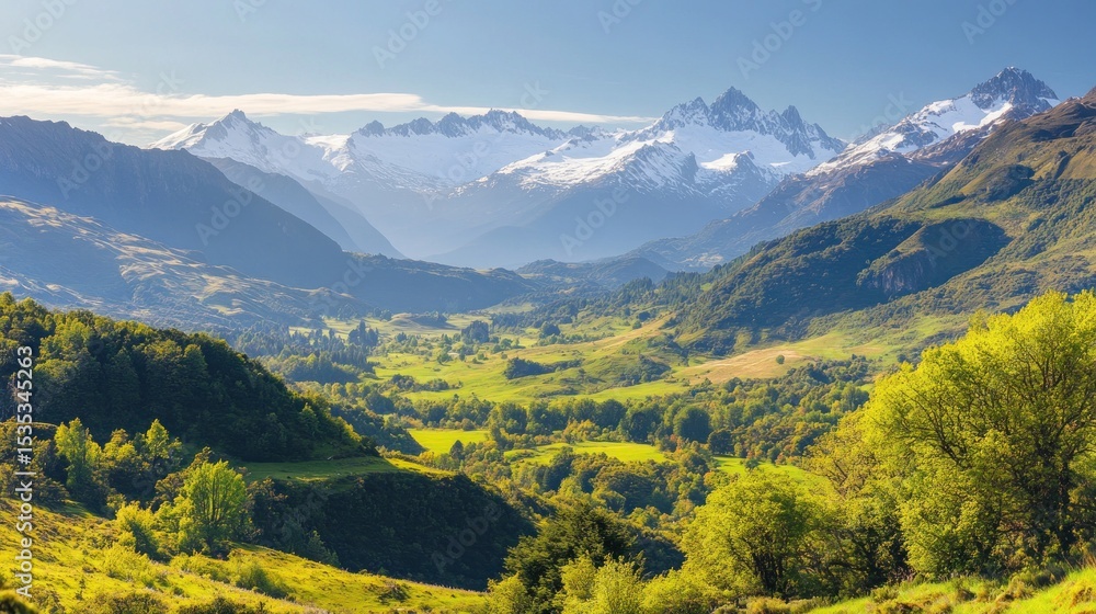 Fototapeta premium Vibrant panoramic view of layered mountains and valleys with snow peaks