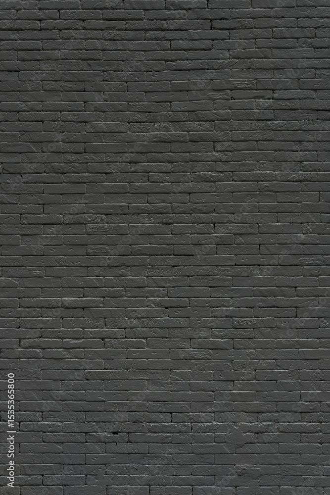 Obraz premium A textured black brick wall bears the marks of time and urban history. Its warm hue and rough surface evoke a sense of nostalgia, craftsmanship, and industrial charm.