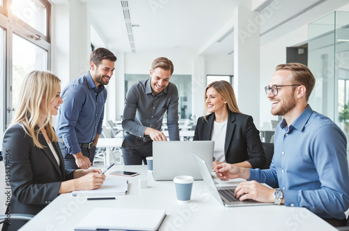 Diverse IT Team Collaborating at Modern Office Workspace – Tech Professionals Using Laptops and Digital Devices for IT Workplace and System Administrator Day