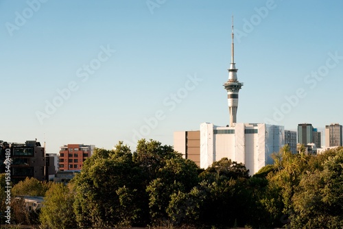 Фотография Auckland Skyline Peeking Through Lush Green Trees