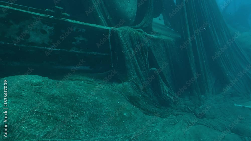 Ghost fishing nets drape from the mast of a sunken trawler in the Red ...