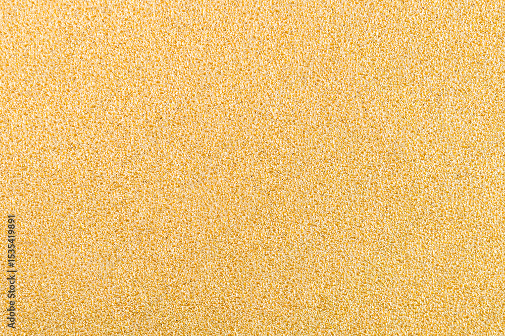 Gold wall texture background. Yellow shiny gold foil paint on wall sheet with gloss light reflection. Gold wall texture background. Yellow shiny gold foil paint on wall sheet with gloss light reflection.