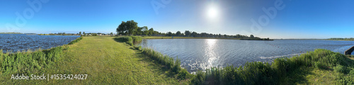 Panoramic picture of a small beach at a lake