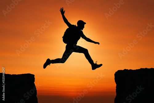 Wallpaper Mural A silhouette leaps confidently between rocky cliffs at sunset symbolizing ambition and overcoming challenges in business Torontodigital.ca