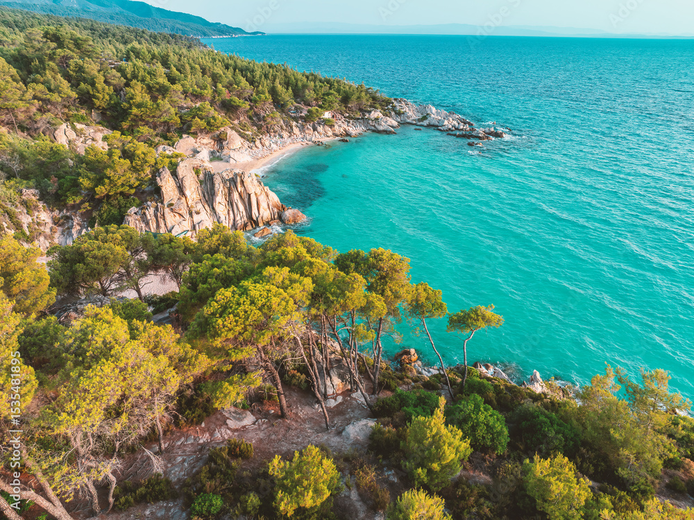 Obraz premium Paradise Kavourotripes Beach, Chalkidiki, Greece. Aerial view of beautiful wild beach shore island with turquoise waters