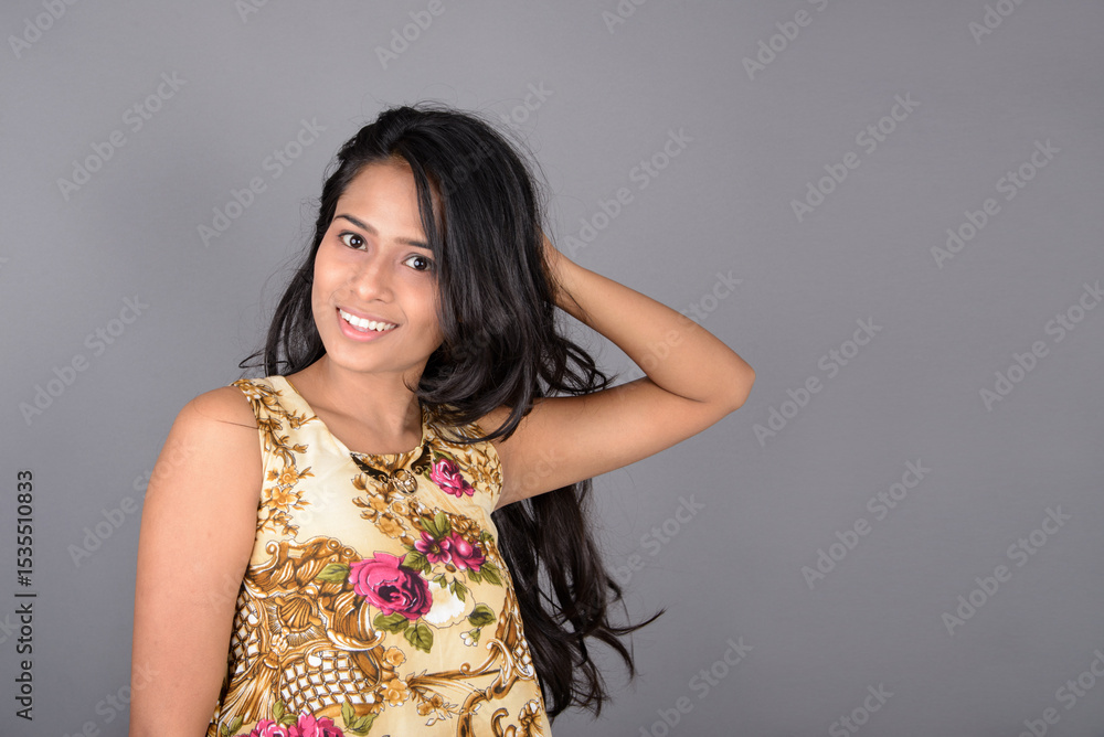 A charming young woman wearing a floral patterned top, black leggings and black heels, posing with jovial facial expressions and different emotions showcasing modern style, elegance. A charming young woman wearing a floral patterned top, black leggings and black heels, posing with jovial facial expressions and different emotions showcasing modern style, elegance.
