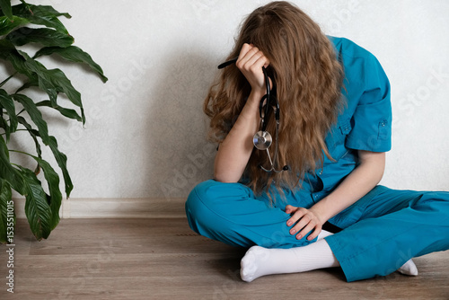 Medical student studies diligently while feeling overwhelmed at a desk in a quiet study space