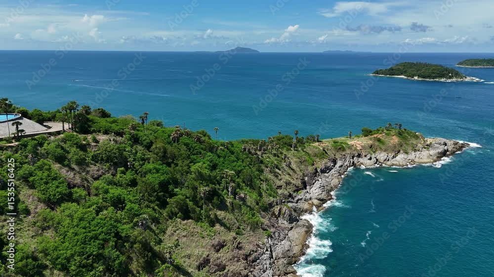 Picturesque small island located in the middle of the vast ocean surrounded by blue waters Picturesque small island located in the middle of the vast ocean surrounded by blue waters