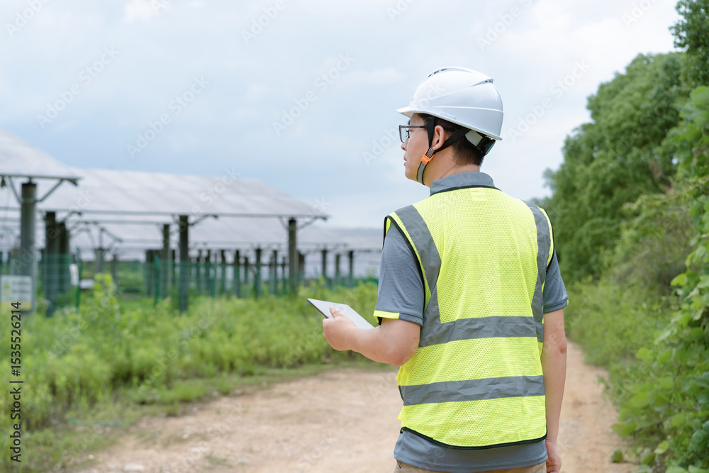 asian engineer woking with digital tablet in solar power site asian engineer woking with digital tablet in solar power site