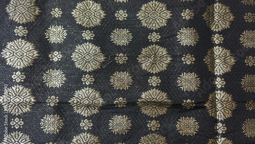 Black songket, traditional Malay woven textile with beautiful pattern made from golden sewing