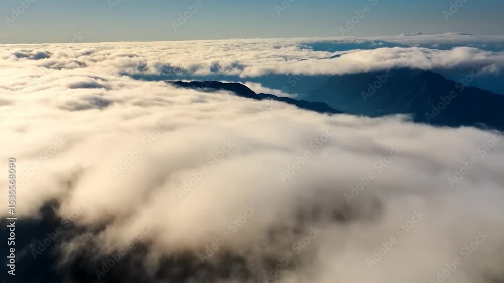 Majestic mountain peaks above clouds Majestic mountain peaks above clouds