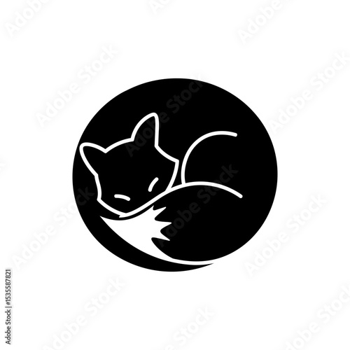 Curled fox sleeping in tight circle on natural ground