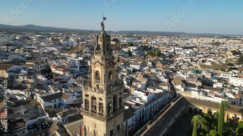 Aerial view from a drone of the Mosque-Cathedral of Córdoba, Spain and city view at sunset. Iconic blend of Islamic and Christian architecture in a historic Andalusian cityscape.