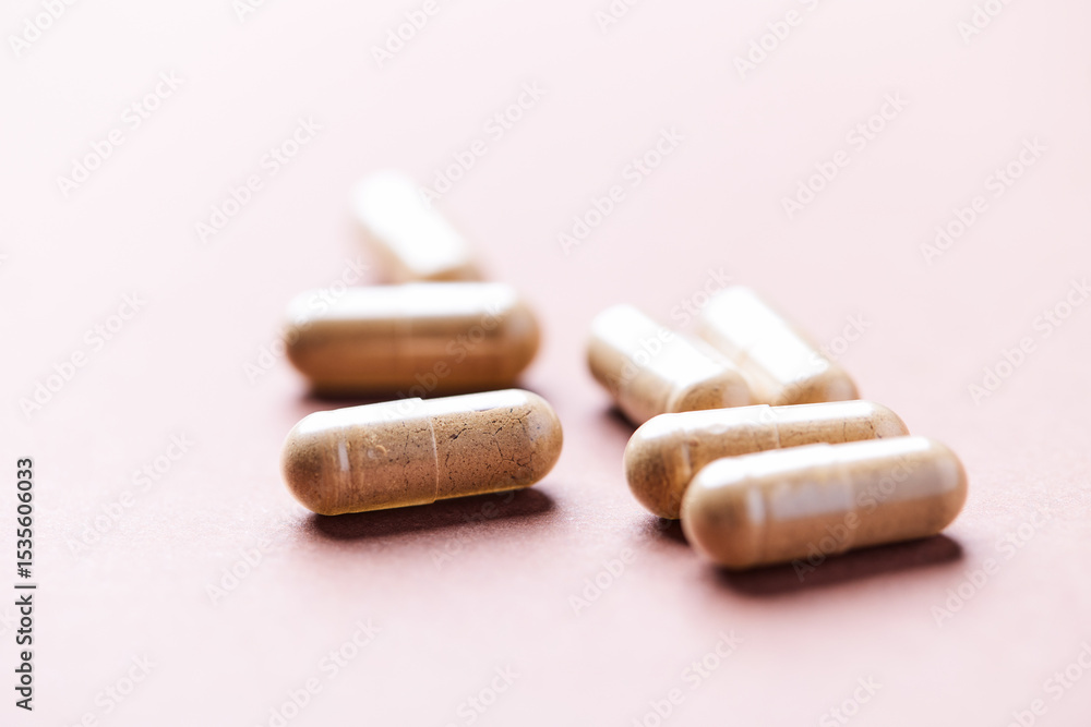 Reishi capsules. Concept for a healthy dietary supplementation. Paper background. Soft focus. Close up. Reishi capsules. Concept for a healthy dietary supplementation. Paper background. Soft focus. Close up.