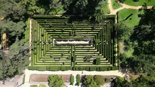 Aerial view from a drone of the hedge maze in the Royal Alcázar of Seville, Spain. Historic garden design ideal for tourism, architecture, and cultural heritage themes.